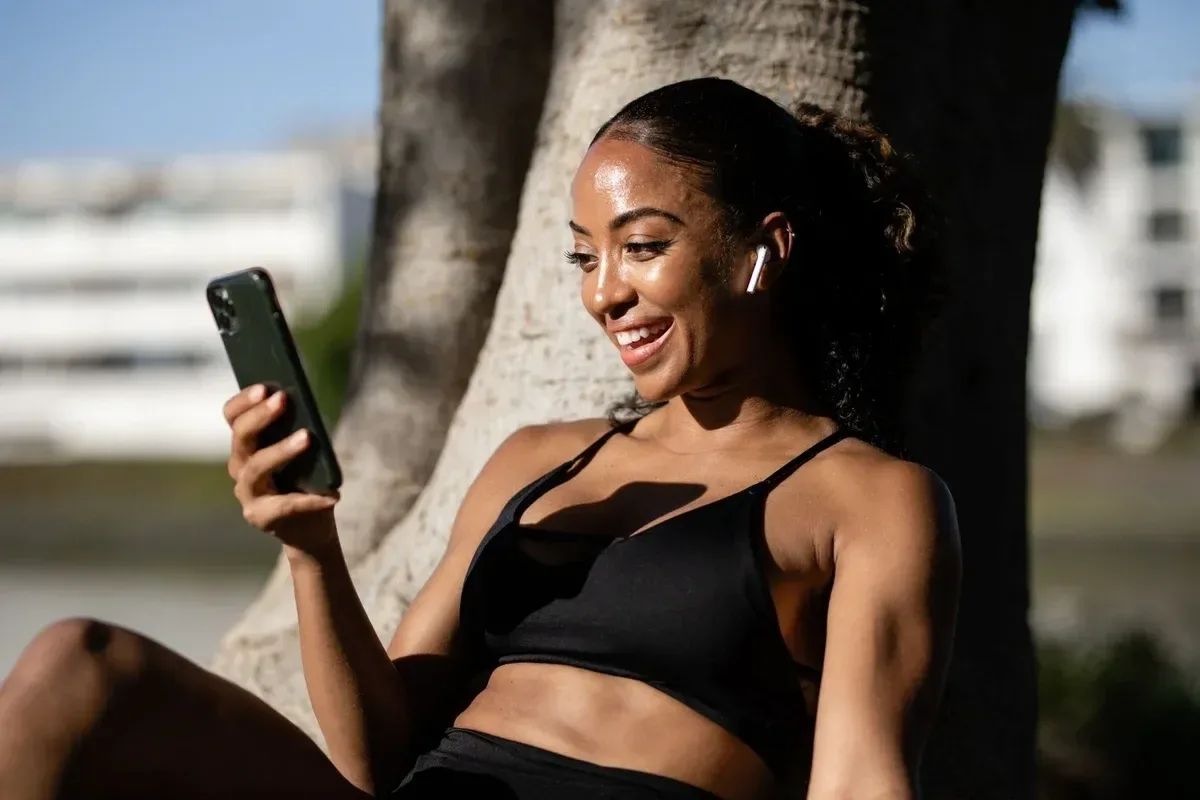 Smiling Trainer Talking to Client on her Phone